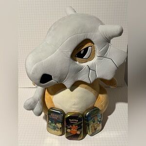 24in Cubone Pokémon plush and three Pokémon card cases